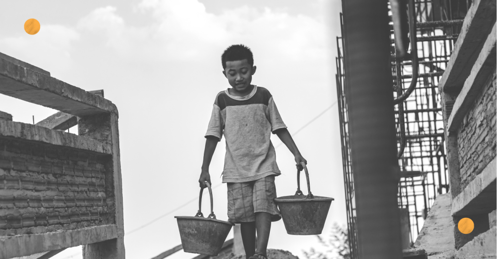 A kid carrying buckets of water.