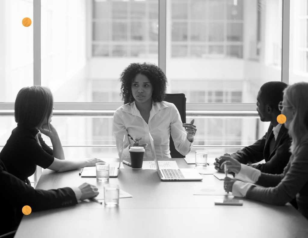 A woman CEO leading a business meeting attended mostly by women. Organizations that are majority-owned, controlled and managed by women are certified by WBE Canada.