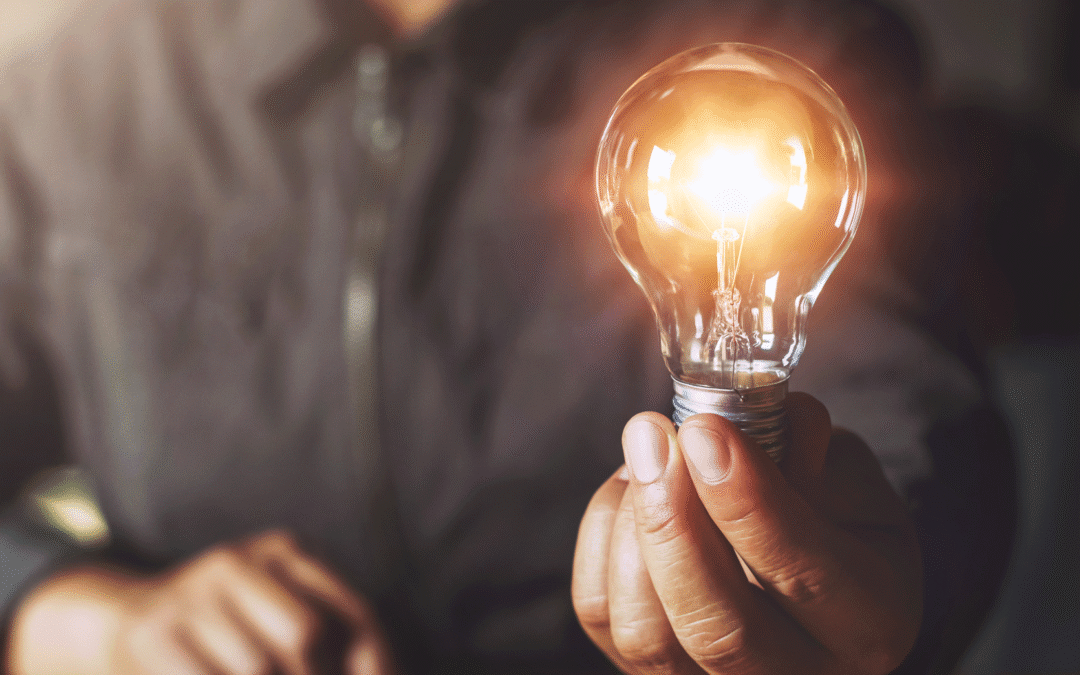 hand holding light bulb
